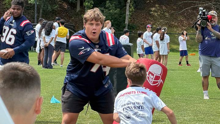 New England Patriots offensive tackle Caleb Lomu takes part in football drills with kids in Newton, Massachusetts. New England Patriots offensive tackle Caleb Lomu takes part in football drills with kids in Newton, Massachusetts.