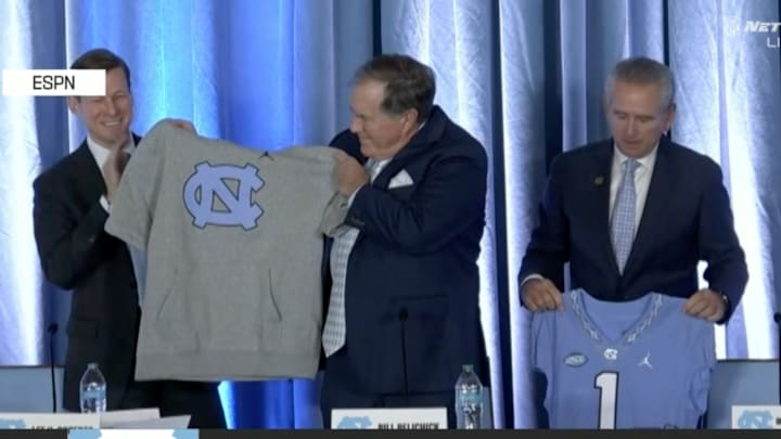 Belichick receives his signature cut-off hoodie.