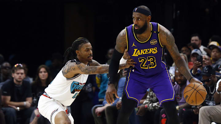 Mar 29, 2025; Memphis, Tennessee, USA; Los Angeles Lakers forward LeBron James (23) dribbles as Memphis Grizzlies guard Ja Morant (12) defends during the third quarter at FedExForum. Mandatory Credit: Petre Thomas-Imagn Images Mar 29, 2025; Memphis, Tennessee, USA; Los Angeles Lakers forward LeBron James (23) dribbles as Memphis Grizzlies guard Ja Morant (12) defends during the third quarter at FedExForum. Mandatory Credit: Petre Thomas-Imagn Images