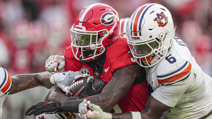 Georgia Bulldogs running back Nate Frazier (3) is tackled by Auburn Tigers safety Jerrin Thompson (1) and linebacker Austin Keys (6) during the second half at Sanford Stadium. Georgia Bulldogs running back Nate Frazier (3) is tackled by Auburn Tigers safety Jerrin Thompson (1) and linebacker Austin Keys (6) during the second half at Sanford Stadium.