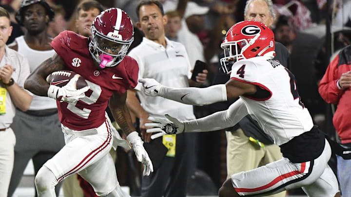 Sep 28, 2024; Tuscaloosa, Alabama, USA;  Alabama Crimson Tide wide receiver Ryan Williams (2) breaks a tackle by Georgia Bulldogs defensive back KJ Bolden (4) to score a touchdown that put Alabama ahead in the fourth quarter at Bryant-Denny Stadium. Alabama defeated Georgia 41-34. Mandatory Credit: Gary Cosby Jr.-Imagn Images