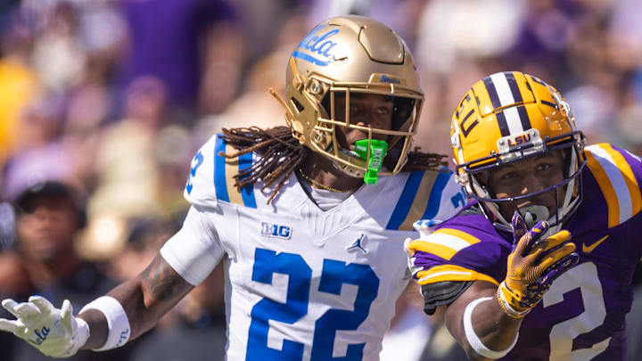 Sep 21, 2024; Baton Rouge, Louisiana, USA;  LSU Tigers wide receiver Kyren Lacy (2) misses a pass against UCLA Bruins defensive back Croix Stewart (22) during the first half at Tiger Stadium. Mandatory Credit: Stephen Lew-Imagn Images