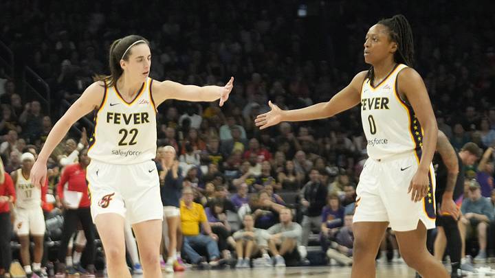 Jun 30, 2024; Phoenix, Ariz., U.S.; Indiana Fever guard Caitlin Clark (22) slaps hands with guard Kelsey Mitchell (0) during the third quarter against the Phoenix Mercury at Footprint Center. Mandatory Credit: Michael Chow-Arizona Republic
