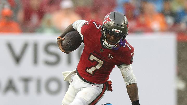 Jan 3, 2026; Tampa, Florida, USA; Tampa Bay Buccaneers running back Bucky Irving (7) runs against Carolina Panthers cornerback Chau Smith-Wade (26) in the first half at Raymond James Stadium. Mandatory Credit: Nathan Ray Seebeck-Imagn Images
