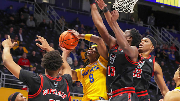 Jan 24, 2026; Pittsburgh, Pennsylvania, USA;  Pittsburgh Panthers guard Omari Witherspoon (8) shoots as NC State Wolfpack guard Quadir Copeland (11) and forwards Musa Sagnia (13) and Ven-Allen Lubin (22) defend during the first half at the Petersen Events Center. Mandatory Credit: Charles LeClaire-Imagn Images
