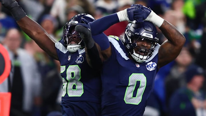 Jan 17, 2026; Seattle, WA, USA; Seattle Seahawks linebacker Derick Hall (58) and defensive end DeMarcus Lawrence (0) react after a strip sack of San Francisco 49ers quarterback Brock Purdy during the second half in an NFC Divisional Round game at Lumen Field. Mandatory Credit: Kevin Ng-Imagn Images