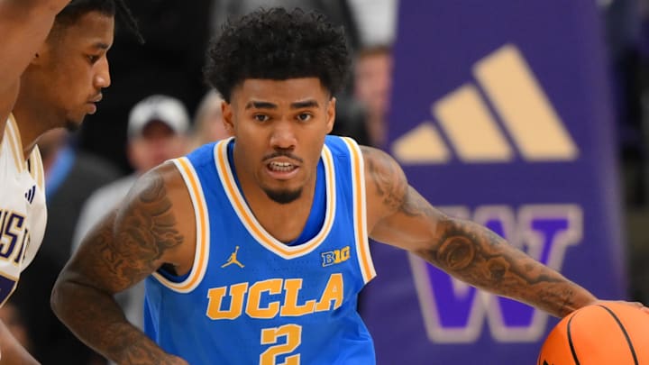 Dec 3, 2025; Seattle, Washington, USA; UCLA Bruins guard Donovan Dent (2) moves the ball down court while guarded by Washington Huskies guard Wesley Yates III (9) during the second half at Alaska Airlines Arena at Hec Edmundson Pavilion. Mandatory Credit: Steven Bisig-Imagn Images