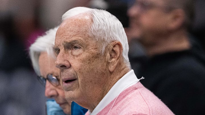 Feb 28, 2026; Charlotte, North Carolina, USA; former North Carolina basketball coach Roy Williams sits courtside at Spectrum Center for a game between the Charlotte Hornets and the Portland Trail Blazers. Mandatory Credit: Scott Kinser-Imagn Images