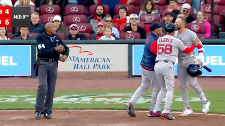 Umpire C.B. Bucknor watches as Trevor Story is escorted back to the dugout by coaches. Umpire C.B. Bucknor watches as Trevor Story is escorted back to the dugout by coaches.