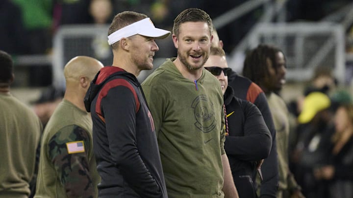 Nov 11, 2023; Eugene, Oregon, USA; USC Trojans head coach Lincoln Riley, left, and Oregon Ducks head coach Dan Lanning talk before a game at Autzen Stadium. 