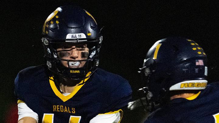Regina's Aiden Gaffey (14) hands the ball to Holt Hinkel (1) Oct. 2, 2026 during a high school football game against the Sigourney Keota Cobras in Iowa City, Iowa. Regina's Aiden Gaffey (14) hands the ball to Holt Hinkel (1) Oct. 2, 2026 during a high school football game against the Sigourney Keota Cobras in Iowa City, Iowa.
