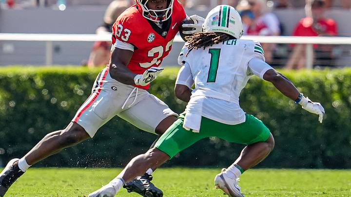 Georgia Bulldogs running back Chauncey Bowens (33) runs against Marshall Thundering Herd defensive back Boogie Trotter (1) Georgia Bulldogs running back Chauncey Bowens (33) runs against Marshall Thundering Herd defensive back Boogie Trotter (1)