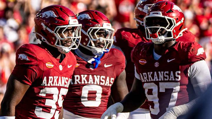 Arkansas Razorbacks defensive linemen Steven Soles, Hunter Osbone and Quincy Rhodes celebrate after a stop against Tennessee Volunteers. Arkansas Razorbacks defensive linemen Steven Soles, Hunter Osbone and Quincy Rhodes celebrate after a stop against Tennessee Volunteers.