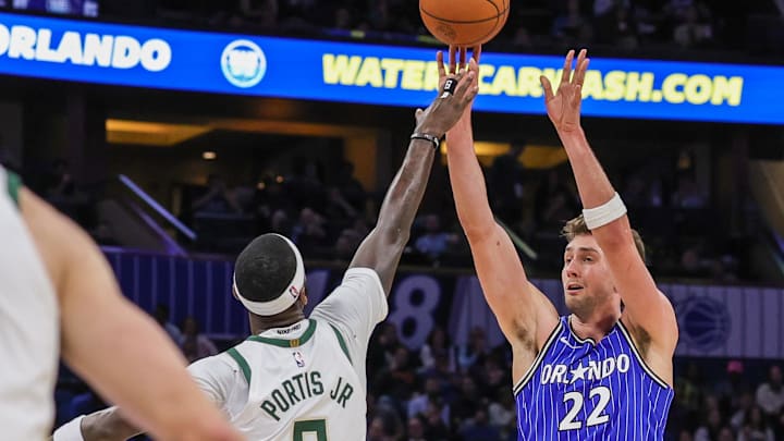 Feb 9, 2026; Orlando, Florida, USA; Orlando Magic forward Franz Wagner (22) shoots against Milwaukee Bucks forward Bobby Portis (9) during the second half at Kia Center. Mandatory Credit: Mike Watters-Imagn Images