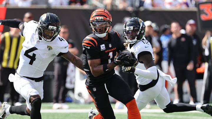 Oct 4, 2026; Cincinnati, Ohio, USA;  Cincinnati Bengals wide receiver Ja'Marr Chase (1) runs with a catch against Jacksonville Jaguars cornerback Jarrian Jones (4) during the second quarter at Paycor Stadium.  Mandatory Credit: Joseph Maiorana-Imagn Images