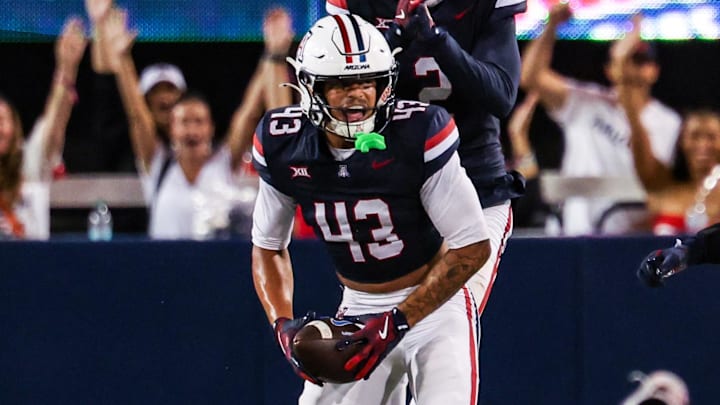 Oct 11, 2025; Tucson, Arizona, USA; Arizona Wildcats defensive back Dalton Johnson (43) celebrates an interception he caught from the Brigham Young Cougars with his team during the third quarter of the game at Arizona Stadium. Mandatory Credit: Aryanna Frank-Imagn Images