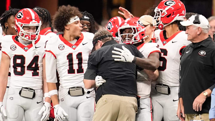 Georgia players celebrate with head coach Kirby Smart during the SEC championship game. The Bulldogs beat the Alabama Crimson Tide.