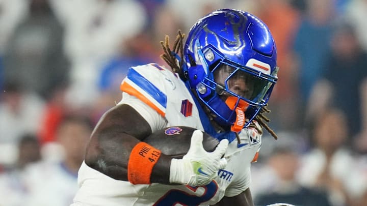Dec 31, 2024; Glendale, AZ, US; Boise State Broncos running back (2) Ashton Jeanty tries to break past Penn State Nittany Lions safety Zakee Wheatley (6) during their Vrbo Fiesta Bowl matchup at State Farm Stadium.