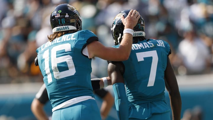 Oct 27, 2024; Jacksonville, Florida, USA; Jacksonville Jaguars quarterback Trevor Lawrence (16) and wide receiver Brian Thomas Jr. (7) celebrate a touchdown against the Green Bay Packers during the third quarter at EverBank Stadium. Mandatory Credit: Morgan Tencza-Imagn Images