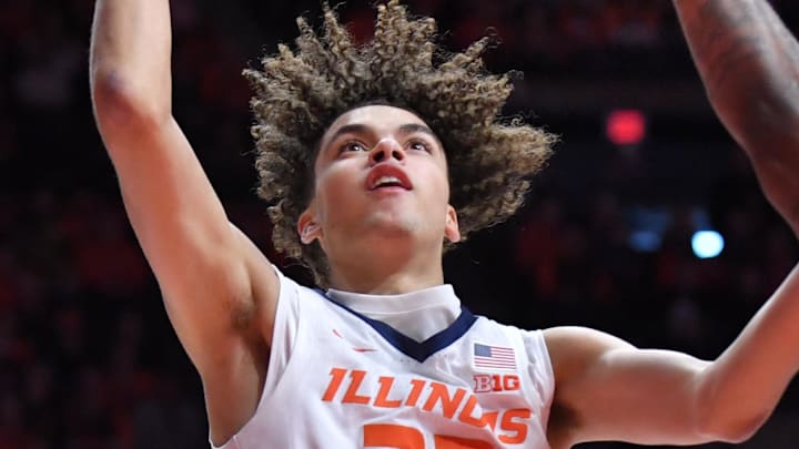 Jan 17, 2026; Champaign, Illinois, USA;  Illinois Fighting Illini guard Keaton Wagler (23) drives past Minnesota Golden Gophers guard Langston Reynolds (6) during the first half at State Farm Center. Mandatory Credit: Ron Johnson-Imagn Images