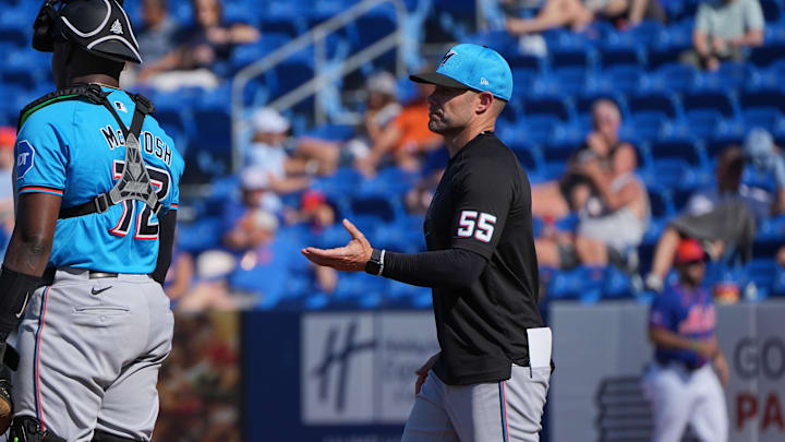 Feb 27, 2024; Port St. Lucie, Florida, USA;  Miami Marlins manager Skip Schumacher (55) takes the ball from pitcher Kent Emanuel (74) in the seventh inning during a game against the New York Mets at Clover Park. Mandatory Credit: Jim Rassol-Imagn Images