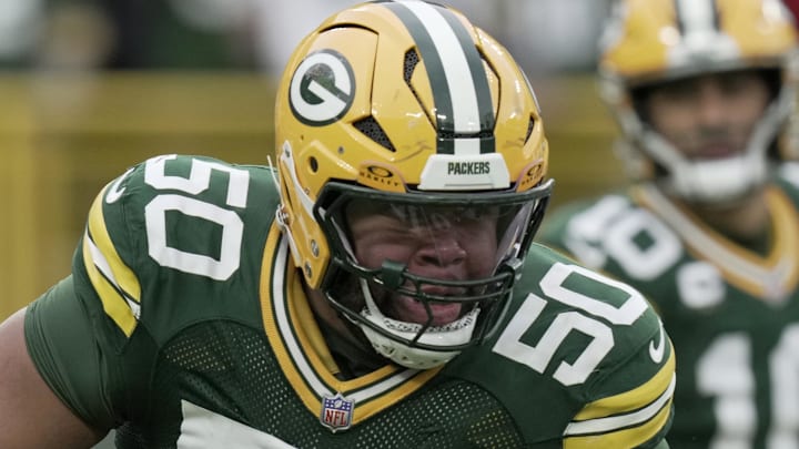 Green Bay Packers right tackle Zach Tom (50) leads a play against the Minnesota Vikings at Lambeau Field. 
