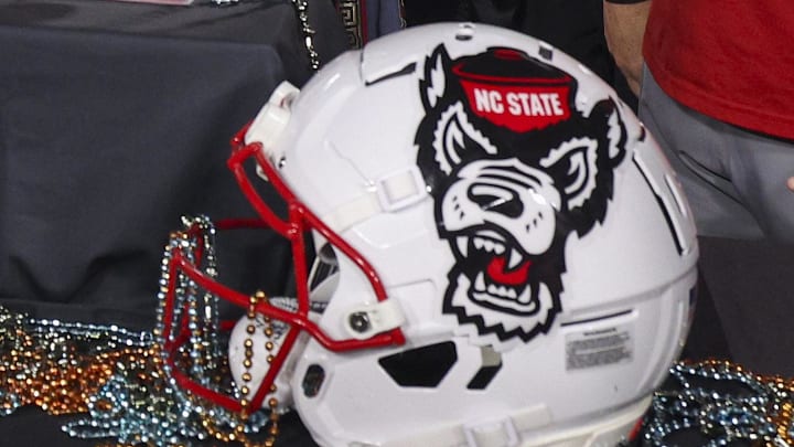 Dec 19, 2025; Tampa, FL, USA; NC State Wolfpack linebacker Caden Fordham (1) receives the MVP trophy after beating Memphis Tigers in the Gasparilla Bowl at Raymond James Stadium. Mandatory Credit: Nathan Ray Seebeck-Imagn Images
