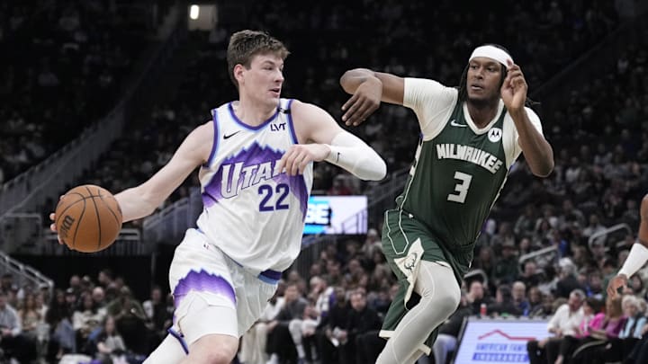 Mar 7, 2026; Milwaukee, Wisconsin, USA; Utah Jazz center Kyle Filipowski (22) drives against Milwaukee Bucks center/forward Myles Turner (3) in the first half at Fiserv Forum. Mandatory Credit: Michael McLoone-Imagn Images