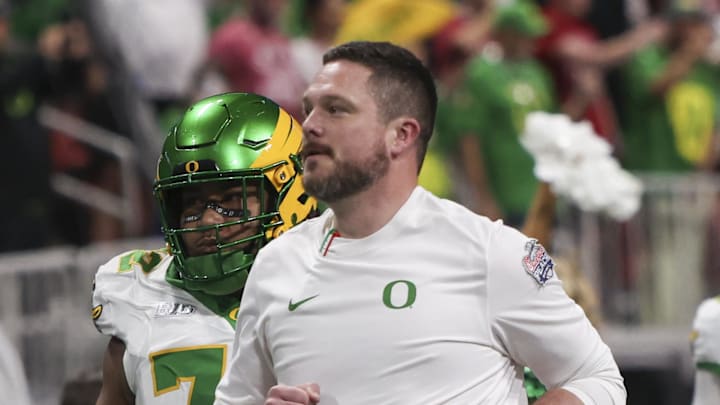 Jan 9, 2026; Atlanta, GA, USA; Oregon Ducks head coach Dan Lanning leads his team onto the field prior to the 2025 Peach Bowl and semifinal game of the College Football Playoff against the Indiana Hoosiers at Mercedes-Benz Stadium. 