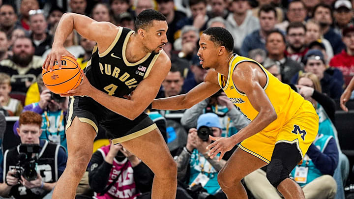 Purdue forward Trey Kaufman-Renn (4) looks to pass against Michigan guard Nimari Burnett (4).