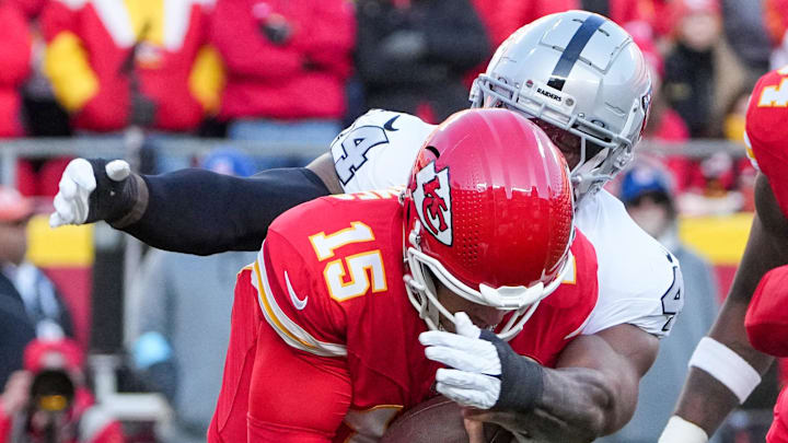 Nov 29, 2024; Kansas City, Missouri, USA; Kansas City Chiefs quarterback Patrick Mahomes (15) is sacked by Las Vegas Raiders defensive end K'Lavon Chaisson (44) during the first half at GEHA Field at Arrowhead Stadium. Mandatory Credit: Denny Medley-Imagn Images