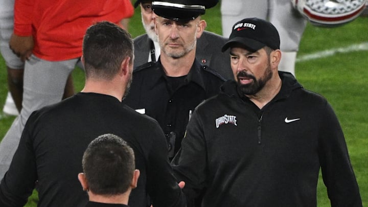 Jan 1, 2025; Pasadena, CA, USA; Ohio State Buckeyes head coach Ryan Day (right) shakes hands with Oregon Ducks head coach Dan Lanning at the conclusion of the Rose Bowl game at Rose Bowl Stadium. Mandatory Credit: Robert Hanashiro-Imagn Images