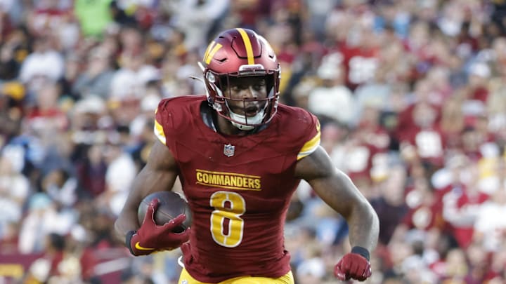 Oct 20, 2024; Landover, Maryland, USA; Washington Commanders running back Brian Robinson Jr. (8) carries the ball as Carolina Panthers cornerback Michael Jackson (2) and Panthers linebacker DJ Johnson (52) defends during the second half at Northwest Stadium. Mandatory Credit: Amber Searls-Imagn Images Oct 20, 2024; Landover, Maryland, USA; Washington Commanders running back Brian Robinson Jr. (8) carries the ball as Carolina Panthers cornerback Michael Jackson (2) and Panthers linebacker DJ Johnson (52) defends during the second half at Northwest Stadium. Mandatory Credit: Amber Searls-Imagn Images