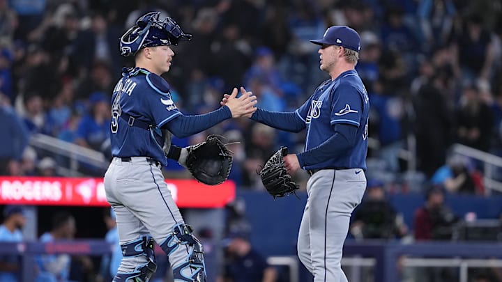 May 12, 2026; Toronto, Ontario, CAN; Tampa Bay Rays catcher Hunter Feduccia (9) celebrates the win with relief pitcher Garrett Cleavinger (60) against the Toronto Blue Jays at the end of the tenth inning at Rogers Centre. 
