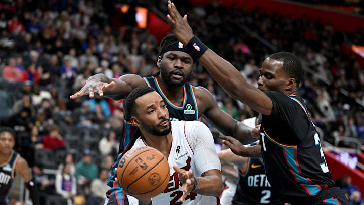 Jan 1, 2026; Detroit, Michigan, USA; Miami Heat guard Norman Powell (24) passes the ball while being double teamed by Detroit Pistons forward Isaiah Stewart (top) and Pistons guard Javonte Green (right) in the fourth quarter at Little Caesars Arena. Mandatory Credit: Lon Horwedel-Imagn Images