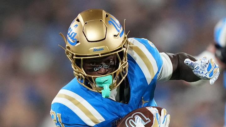 Sep 19, 2026; Pasadena, California, USA; UCLA Bruins running back Jaivian Thomas (21) carries the ball against Purdue Boilermakers defensive back Don Saunders (7) in the first half at the Rose Bowl. Mandatory Credit: Kirby Lee-Imagn Images Sep 19, 2026; Pasadena, California, USA; UCLA Bruins running back Jaivian Thomas (21) carries the ball against Purdue Boilermakers defensive back Don Saunders (7) in the first half at the Rose Bowl. Mandatory Credit: Kirby Lee-Imagn Images