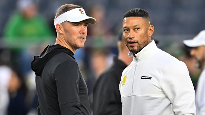 Oct 14, 2023; South Bend, Indiana, USA; USC Trojans head coach Lincoln Riley and Notre Dame Fighting Irish head coach Marcus Freeman chat before the game at Notre Dame Stadium. Mandatory Credit: Matt Cashore-Imagn Images Oct 14, 2023; South Bend, Indiana, USA; USC Trojans head coach Lincoln Riley and Notre Dame Fighting Irish head coach Marcus Freeman chat before the game at Notre Dame Stadium. Mandatory Credit: Matt Cashore-Imagn Images