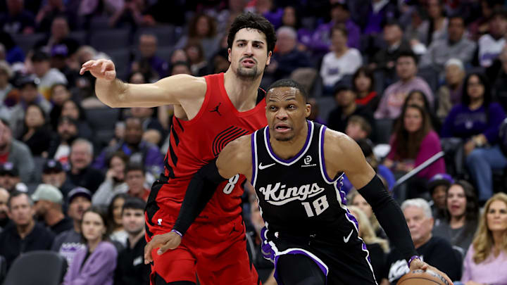 Jan 18, 2026; Sacramento, California, USA; Sacramento Kings guard Russel Westbrook (18) drives around Portland Trail Blazers forward Deni Avdija (8) during the fourth quarter at Golden 1 Center.
