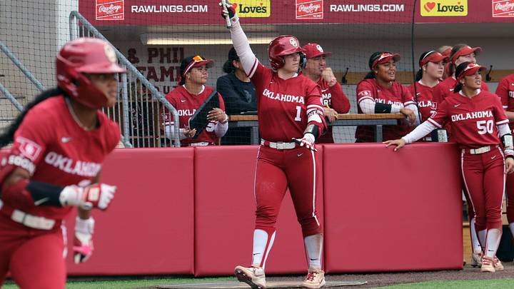 Oklahoma catcher Kendall Wells celebrates a hit from outfielder Kai Minor at Love's Field.