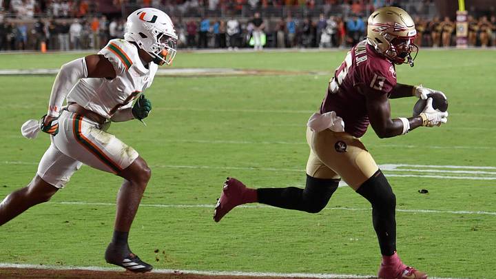 Florida State Seminoles tight end Randy Pittman Jr. (13) catches a touchdown against Miami Hurricanes defensive back Jakobe Thomas (8) 