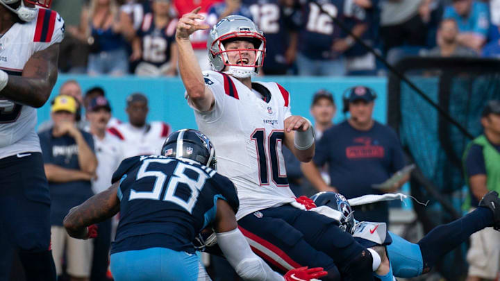 New England Patriots quarterback Drake Maye (10) throws while in the grasp of Tennessee Titans safety Mike Brown (44) during their game at Nissan Stadium in Nashville, Tenn., Sunday, Nov. 3, 2024. It was the last play of regulation and the New England Patriots running back Rhamondre Stevenson (38) came up with the reception in the end zone to force overtime. The play lasted more than 11 seconds as Mayes kept the play alive under constant pressure.