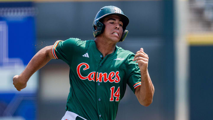 May 23, 2024; Charlotte, NC, USA; Miami (Fl) Hurricanes infielder Daniel Cuvet (14) runs home in the first inning against the Clemson Tigers during the ACC Baseball Tournament at Truist Field. Mandatory Credit: Scott Kinser-Imagn Images