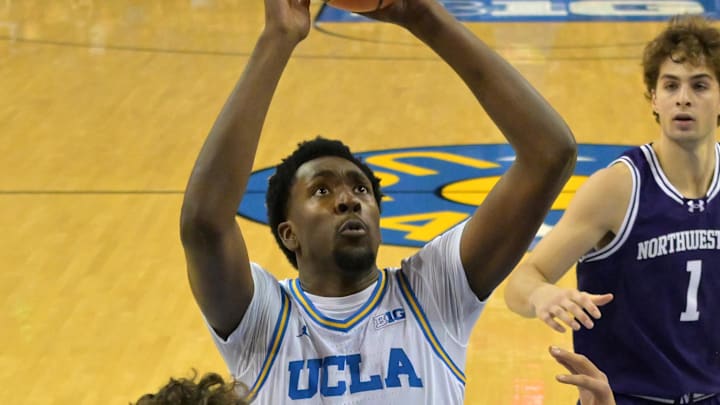 Jan 24, 2026; Los Angeles, California, USA; UCLA Bruins forward Xavier Booker (1) shoots over Northwestern Wildcats forward Nick Martinelli (2), forward Tre Singleton (8) and past forward Tyler Kropp (1) in the first half at Pauley Pavilion presented by Wescom Financial. Mandatory Credit: Jayne Kamin-Oncea-Imagn Images