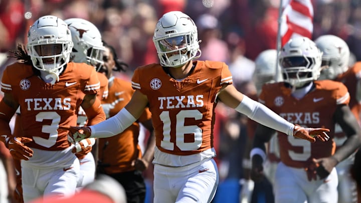 Texas Longhorns defensive back Michael Taaffe (16) leads the team on to the field against the Oklahoma Sooners at the Cotton Bowl.