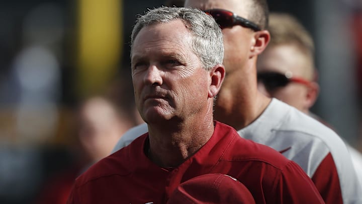 Jun 26, 2018; Omaha, NE, USA; Arkansas Razorbacks Dave Van Horn observes the National Anthem prior to the game against the Oregon State Beavers in game one of the championship series of the College World Series at TD Ameritrade Park. Mandatory Credit: Bruce Thorson-Imagn Images