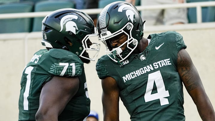 Sep 13, 2025; East Lansing, Michigan, USA; Michigan State offensive lineman Kristian Phillips (71) and running back Elijah Tau-Tolliver (4) celebrate a touchdown against Youngstown State in the fourth quarter at Spartan Stadium.
