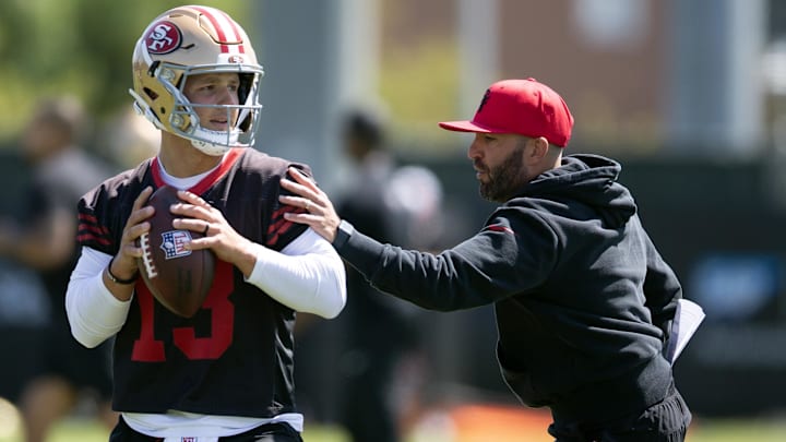 San Francisco 49ers quarterbacks coach harasses Brock Purdy (13) in a passing drill during a team OTA at Levi's Stadium.