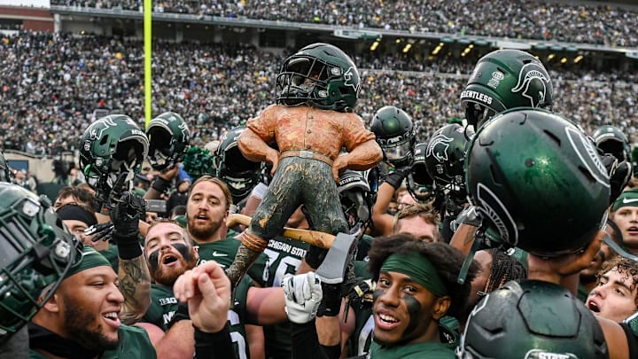 Michigan State celebrates with the Paul Bunyan Trophy after beating Michigan on Saturday, Oct. 30, 2021, at Spartan Stadium in East Lansing. Michigan State celebrates with the Paul Bunyan Trophy after beating Michigan on Saturday, Oct. 30, 2021, at Spartan Stadium in East Lansing.