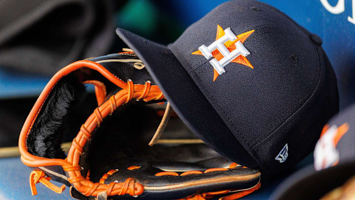 Apr 27, 2025; Kansas City, Missouri, USA; Houston Astros hat and glove in the dugout during the second inning against the Kansas City Royals at Kauffman Stadium. 