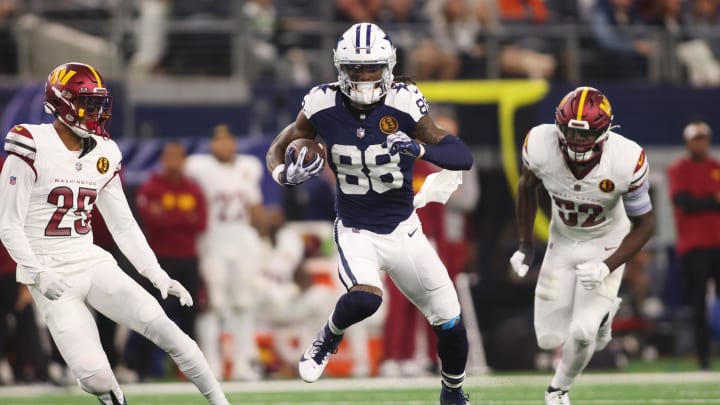 Nov 23, 2023; Arlington, Texas, USA; Dallas Cowboys wide receiver CeeDee Lamb (88) runs the ball after catching a pass against Washington Commanders cornerback Benjamin St-Juste (25) and linebacker Jamin Davis (52) in the second quarter at AT&T Stadium. Mandatory Credit: Tim Heitman-USA TODAY Sports Nov 23, 2023; Arlington, Texas, USA; Dallas Cowboys wide receiver CeeDee Lamb (88) runs the ball after catching a pass against Washington Commanders cornerback Benjamin St-Juste (25) and linebacker Jamin Davis (52) in the second quarter at AT&T Stadium. Mandatory Credit: Tim Heitman-USA TODAY Sports